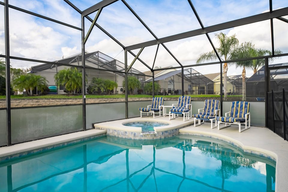 Pool and waterfall spa showing seating and view