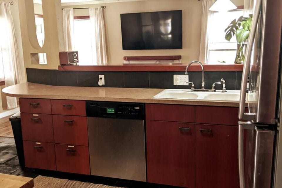 Full size kitchen opens to living room