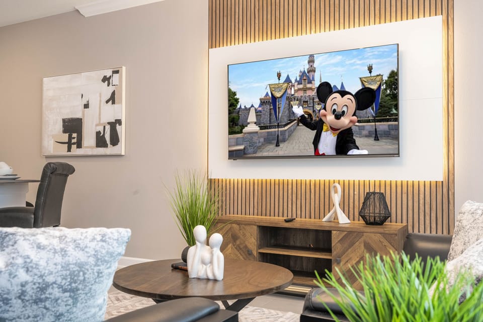 Welcome to our spacious and beautifully adorned living room, complete with a state-of-the-art smart TV where you can stream all your favorite channels and shows. 