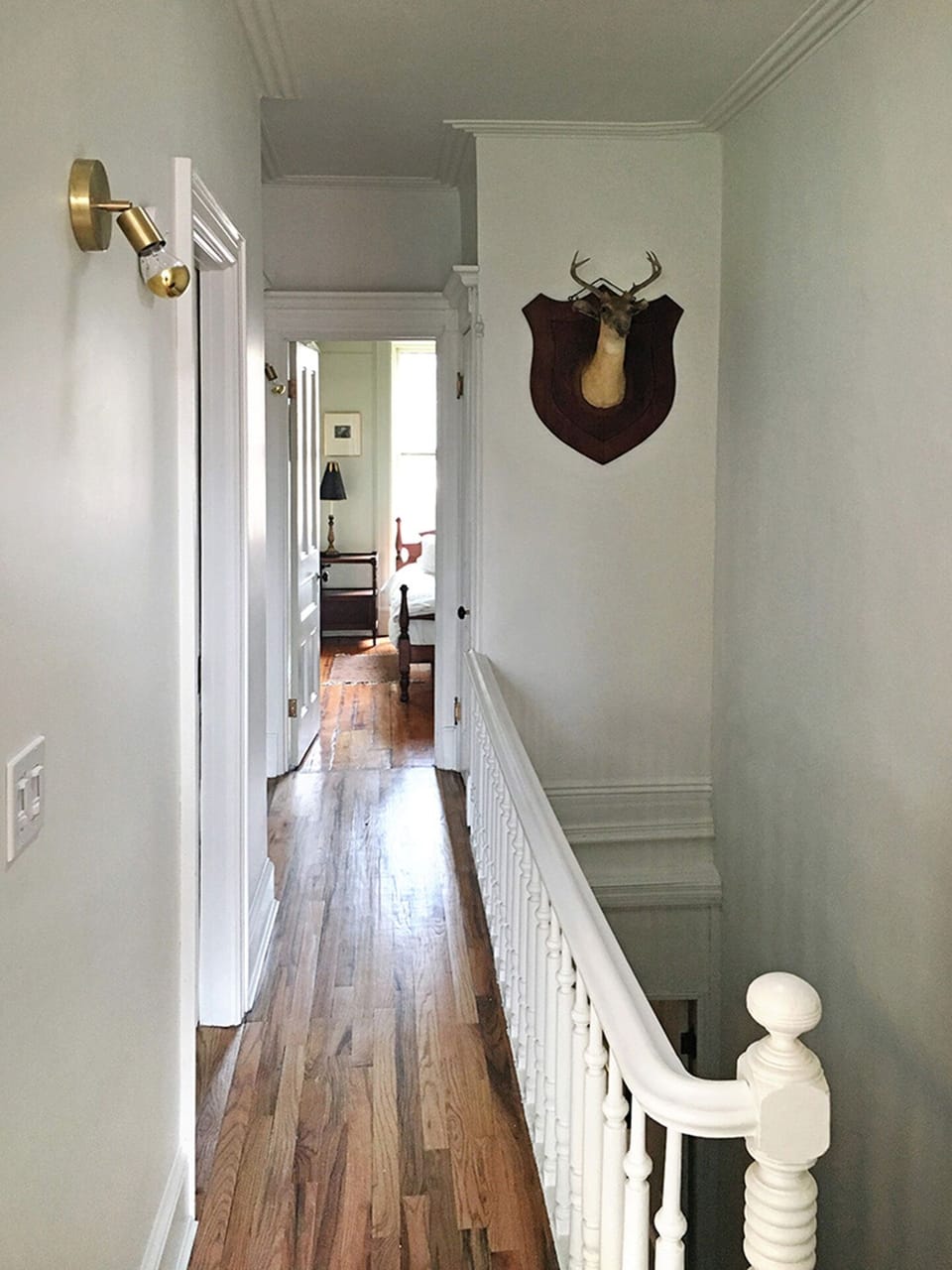 Hallway connecting open kitchen/living room to bathroom and bedrooms.