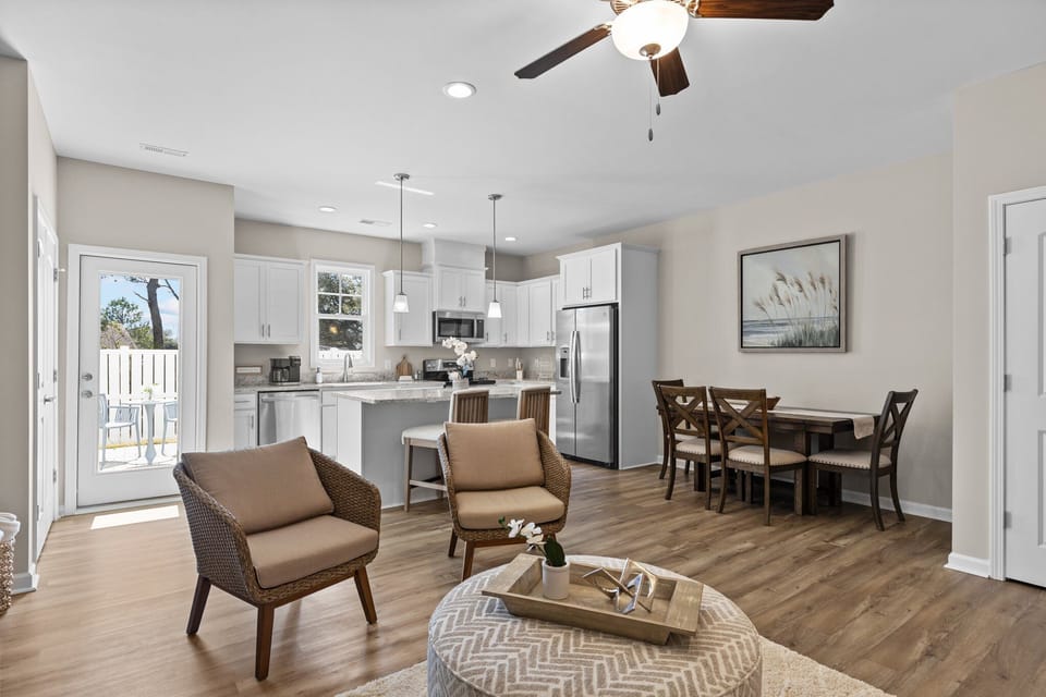Inviting living room flows effortlessly into connected kitchen and dining space.