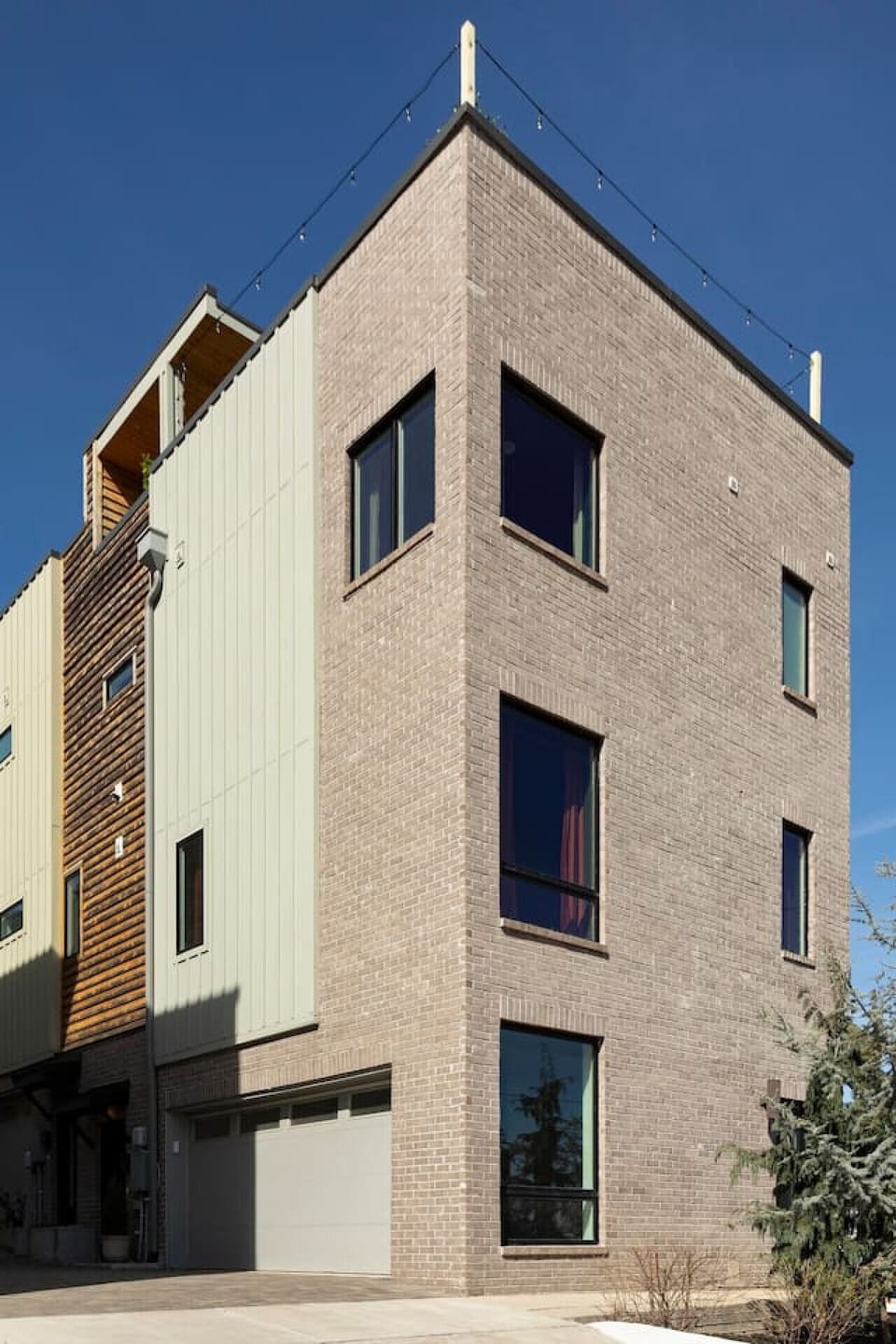 Modern 4-level home with garage and rooftop patio.