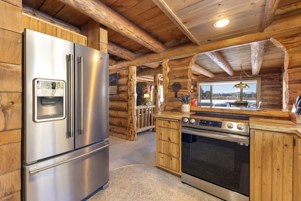 Fully stocked kitchen with a French door fridge and plenty of counter space for the group