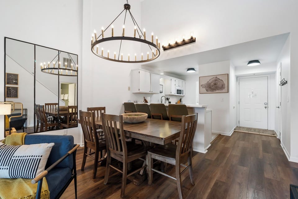 Dining room with chairs and bench seating, along with breakfast bar.