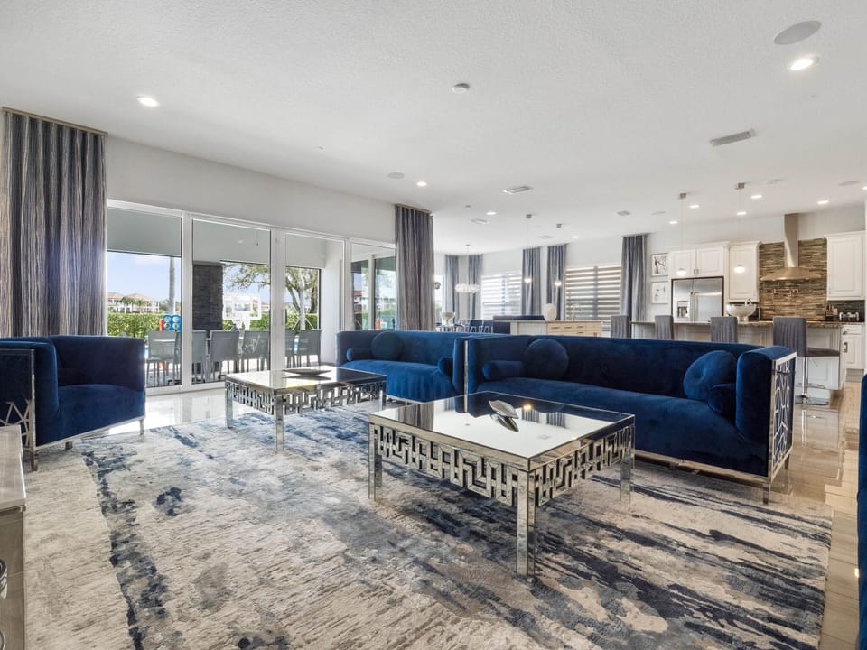 Sink into comfort in our spacious living room, where the serene blue hues of the couch effortlessly complement the plush carpet beneath your feet.