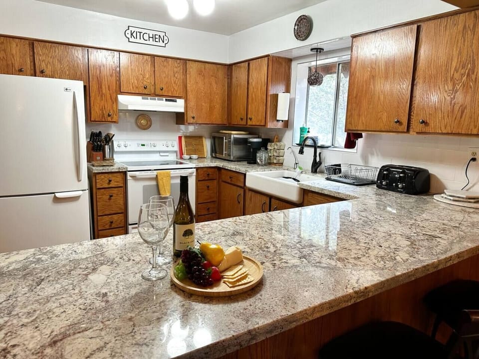 Granite countertops and modern appliances in the fully stocked kitchen