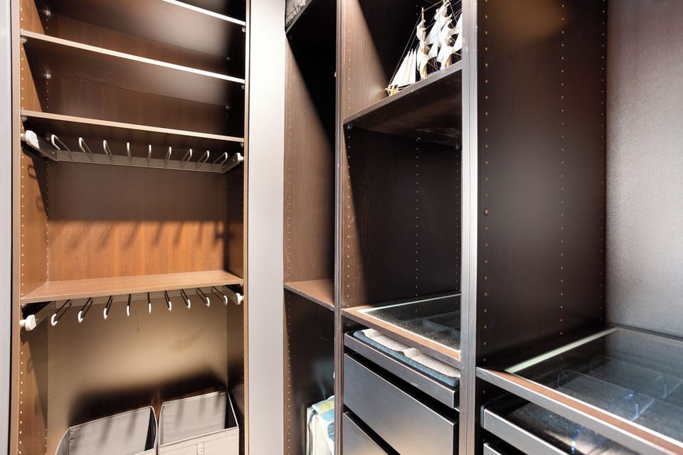 Ensuite bathroom with spacious shower, walk-in closet, dual vanity & amenities.