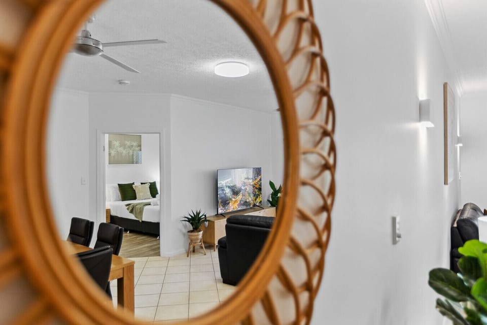 Catch a glimpse of the space through the mirror, adding a touch of elegance and light to the room`s ambiance