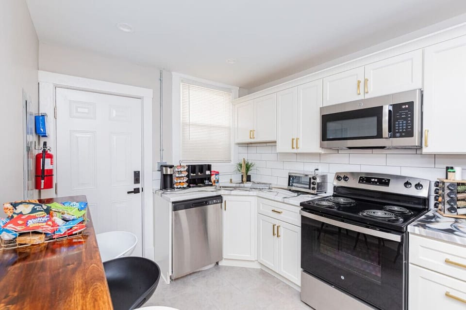 Prepare culinary delights in our fully equipped kitchen, featuring all cooking essentials and meal prepping necessities, along with convenient bar stool seating for casual dining.