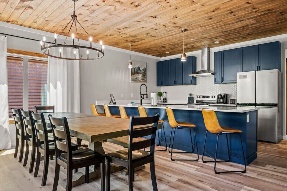 Luxury kitchen area with dining table that seats 10. There is additional seating for 6 at the countertop bar.