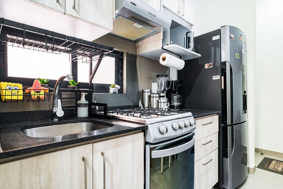 Cocina equipada con estufa, refrigerador y microondas