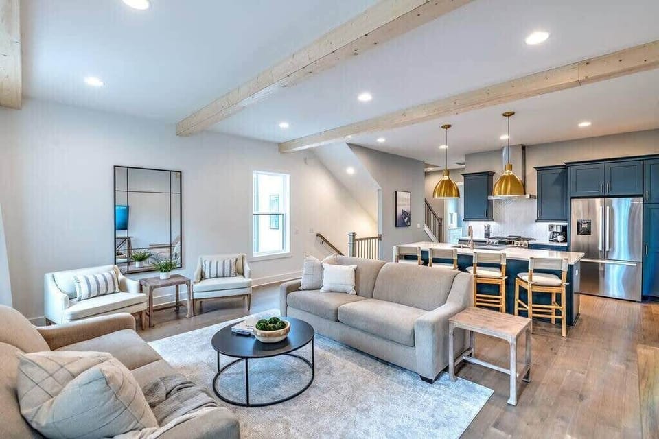 Our beautiful open living room and kitchen with wood beams feels very warm and open thanks to 10 foot ceilings