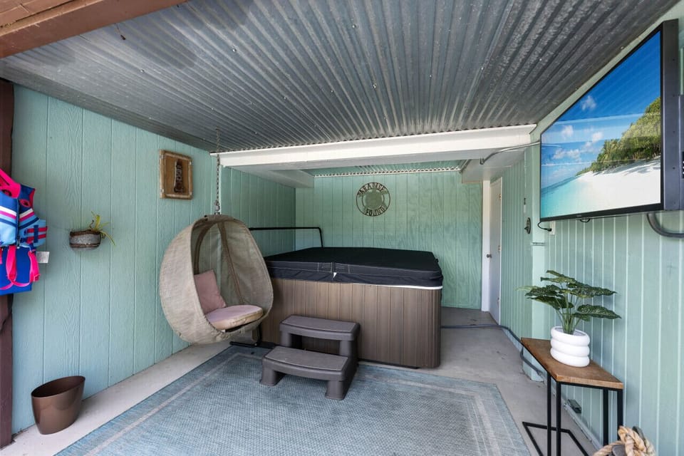Under-deck spa area offering a peaceful soak and hanging swing.