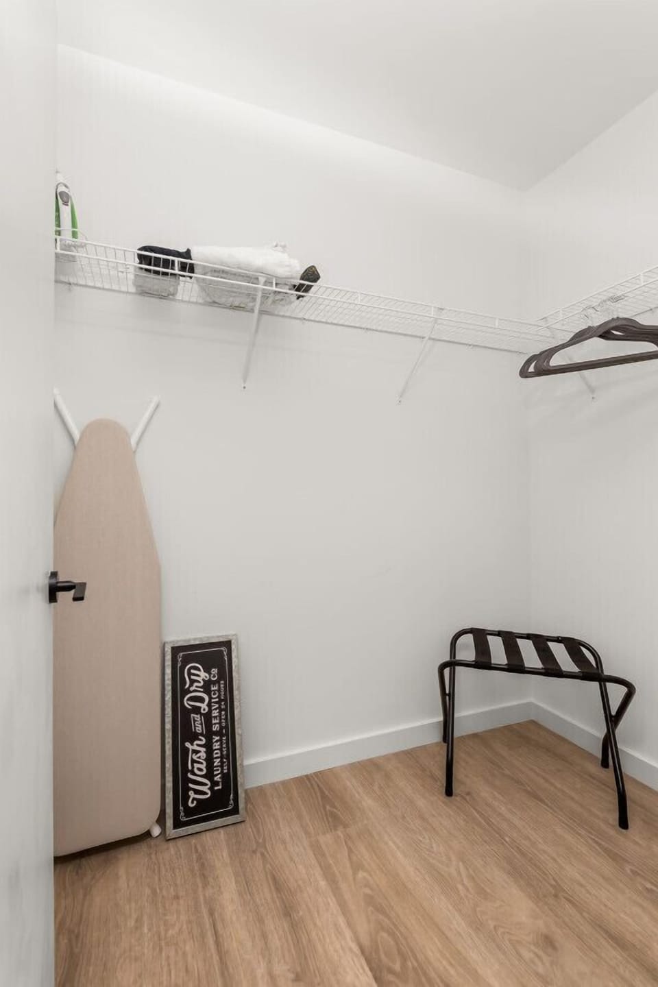 Large closet to tuck away bags and clothes, with iron board and hangers