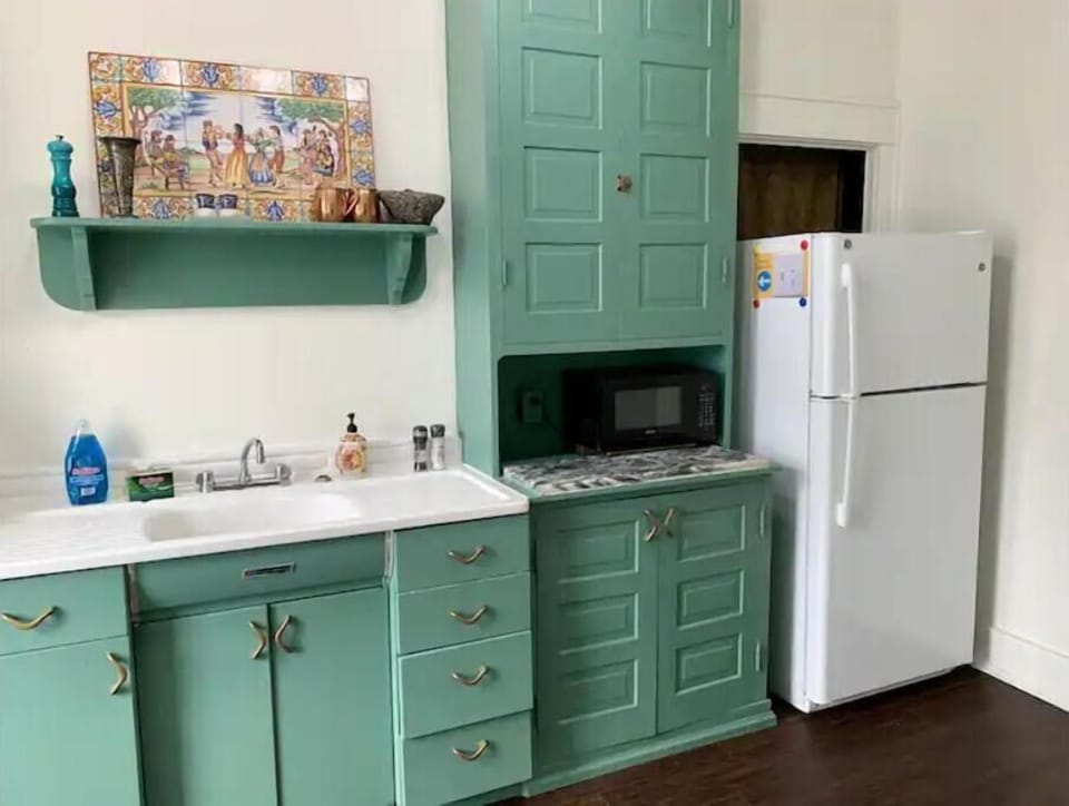 Original built in cabinets in the kitchen showcase this historic buildings charm