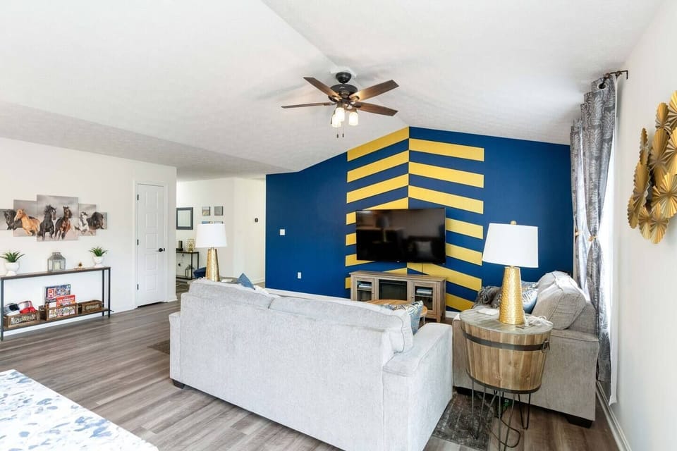 spacious living area with queen sized couch bed, tv, and electric fireplace heater