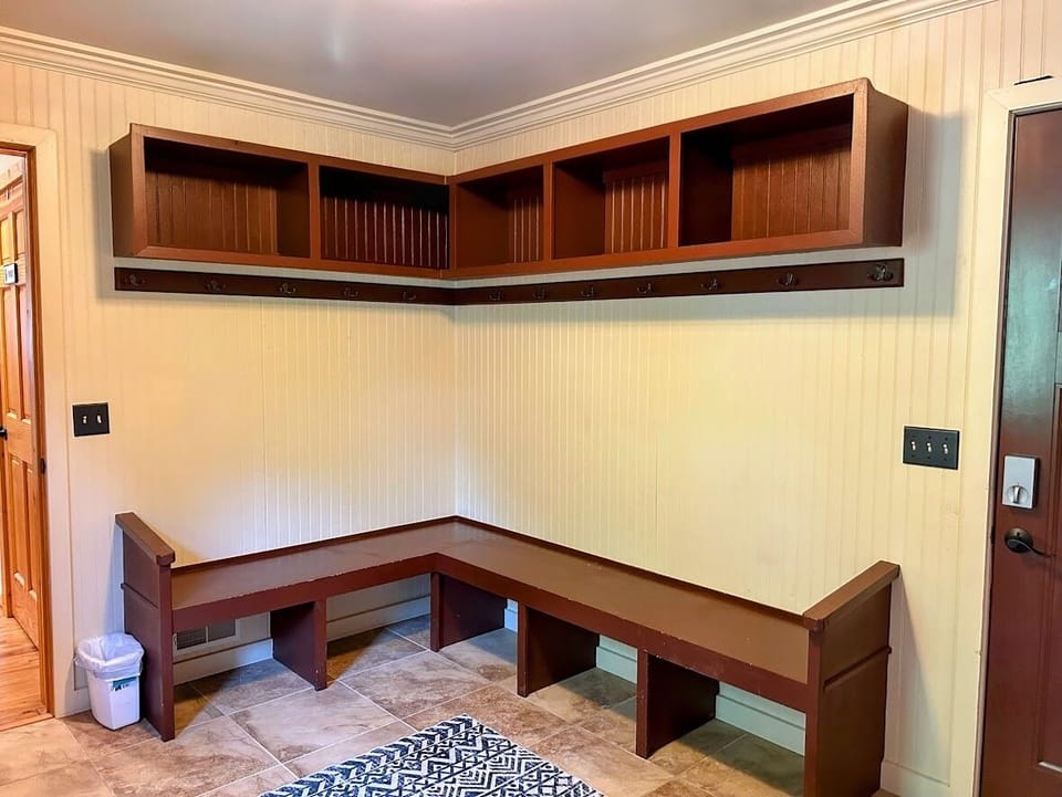 Mud room entrance with plenty of room to store coats, ski gear, and golf clubs 
