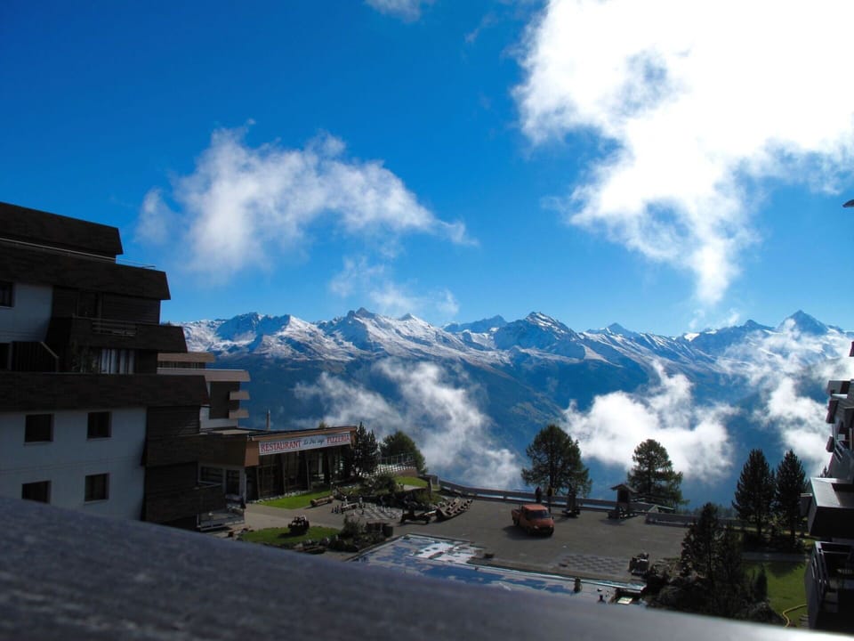 Cloud, Sky, Mountain, Building, Azure, Window, Plant, Highland, Snow, Slope