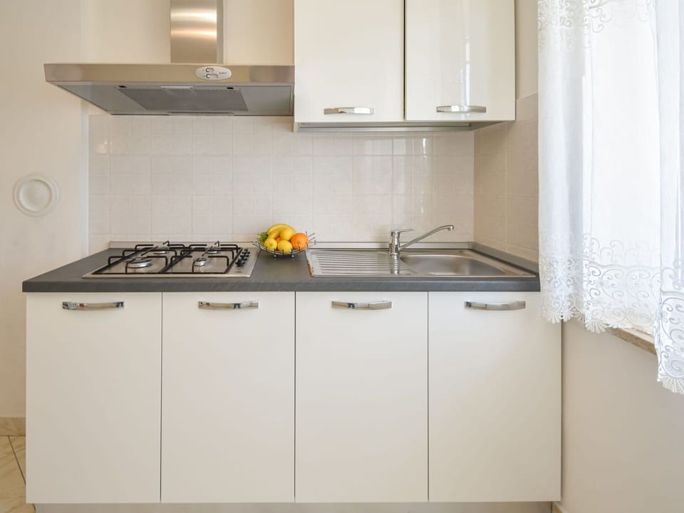 Countertop, Cabinetry, Kitchen Sink, Sink, Tap, Kitchen, Kitchen Stove, Kitchen Appliance, Interior Design, Flooring