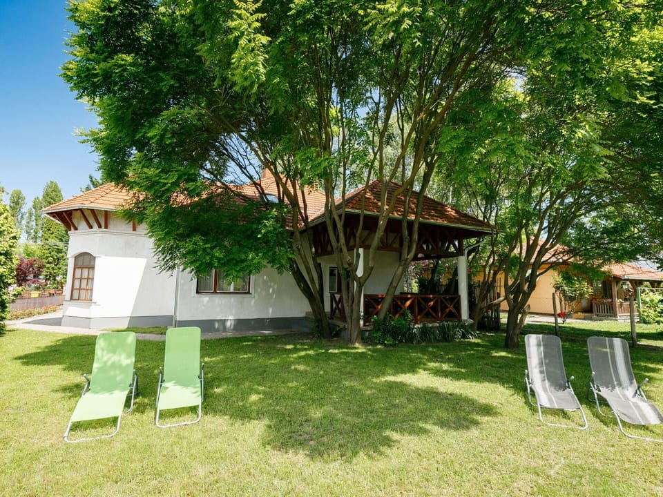 Plant, Building, Tree, Sky, Shade, Land Lot, Cottage, Woody Plant, Grass, Leisure