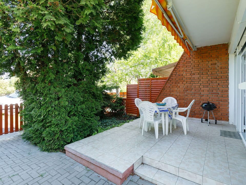 Furniture, Plant, Building, Chair, Table, Shade, Outdoor Furniture, Flooring, Tree, Floor