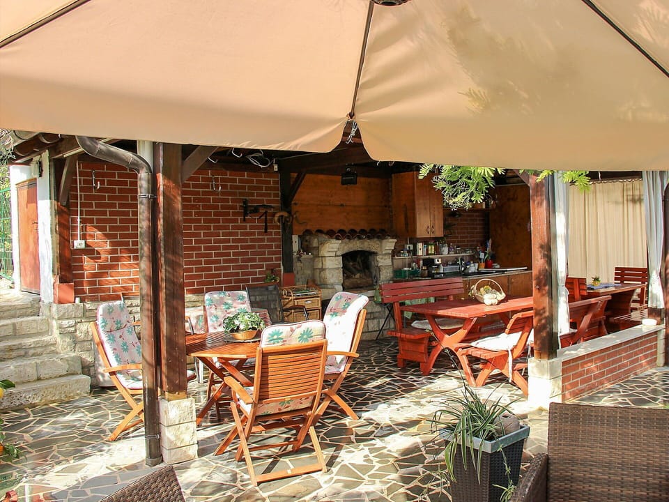 Furniture, Plant, Chair, Building, Window, Table, Outdoor Table, Shade, Outdoor Furniture, Wood