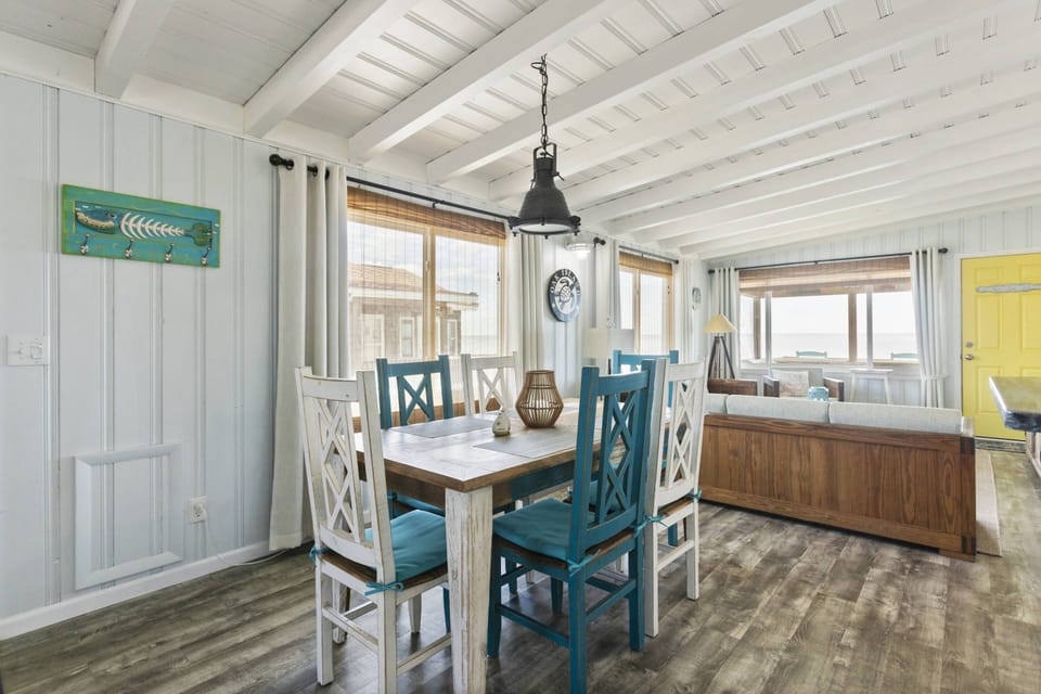 A perfect blend of coastal vibes and culinary delights in this beach house dining area.