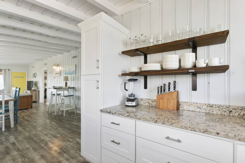 Elevate your cooking experience in this modern kitchen with pristine white cabinets and luxurious granite counter tops.