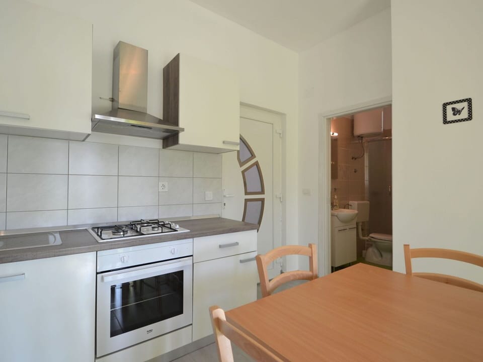 Cabinetry, Furniture, Table, Countertop, Building, Kitchen Stove, Kitchen Appliance, Wood, Home Appliance, Flooring