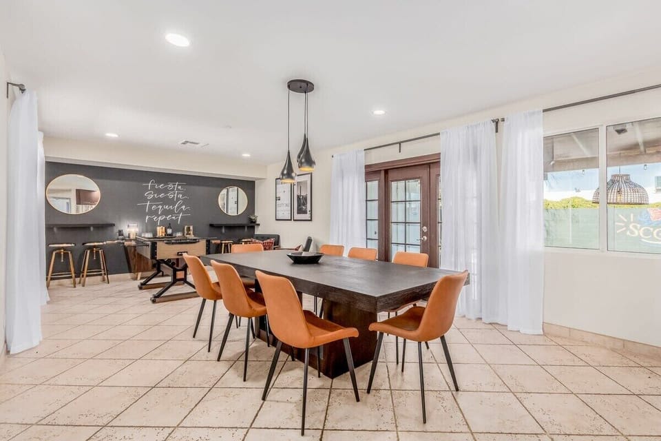 Large open dining room with seating for 8 plus bonus bar area with games