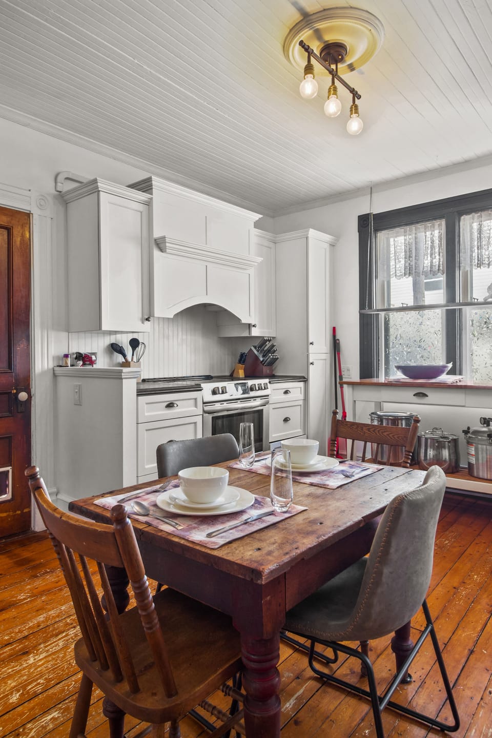 Vintage charm meets everyday comfort—cook, dine, and unwind in this character-filled kitchen with warm wood floors and classic details.
