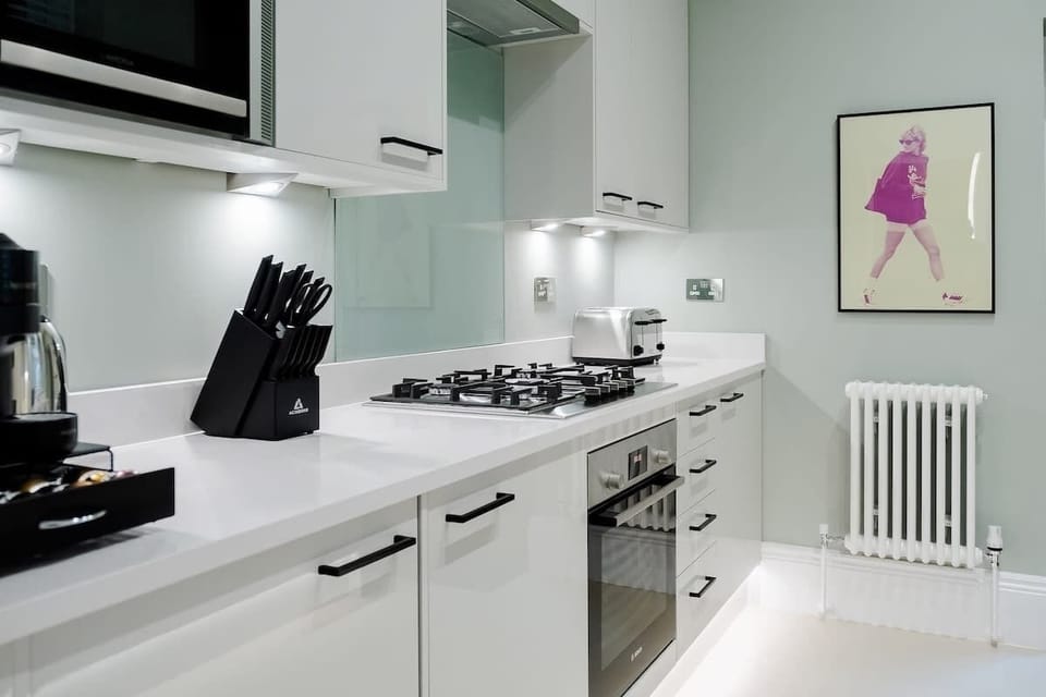Full Kitchen | Impeccably Stocked Kitchen, Featuring Essential Appliances and Luxuries including a Filtered Water Dispenser and Nespresso Machine with Vertuo Pods Provided. Martini, Champagne, and Wine Glasses Included.