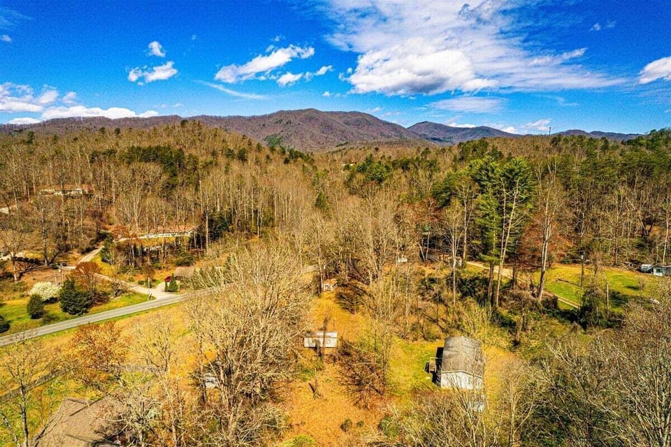 Drone view capturing the Smoky Mountain backdrop and wooded property surroundings.