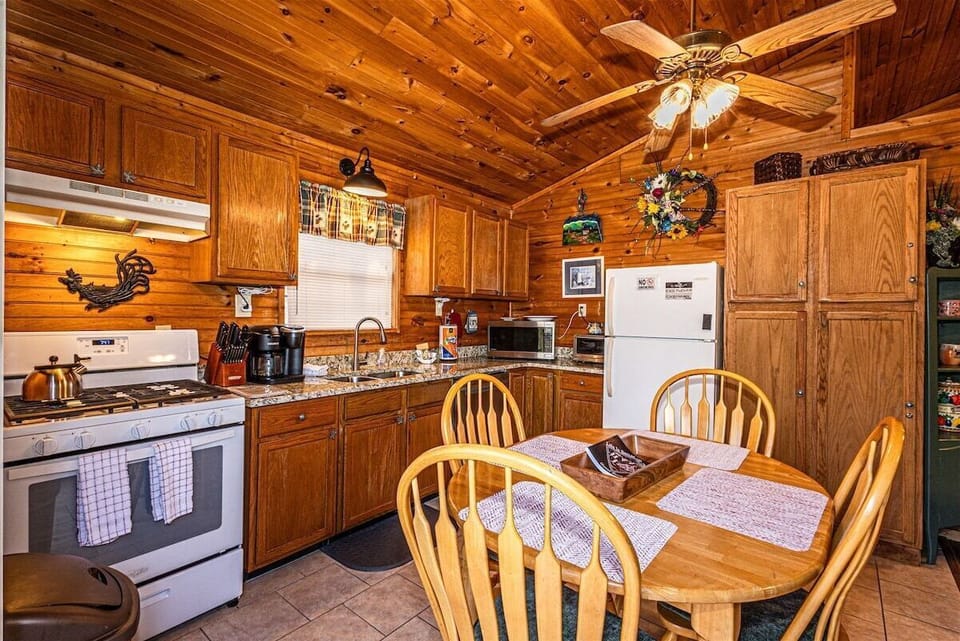 Fully equipped kitchen and dining space at Blue Mist Mountain Retreat with wood cabinetry and table seating for home-cooked meals.