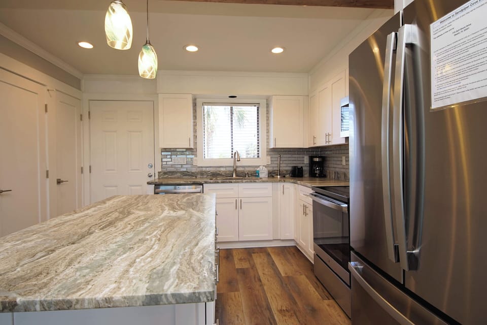Your fully equipped kitchen welcomes you with granite countertops, stainless appliances, and warm hardwood floors for memorable meal preparation.