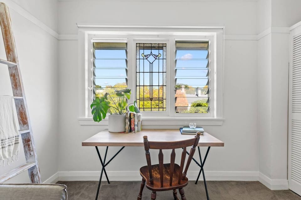 The first bedroom has a charming study nook, perfect for remote workers and creatives.