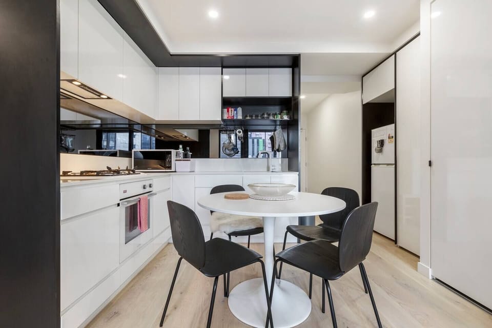 A contemporary and compact corner kitchen that is fully-equipped with premium appliances.