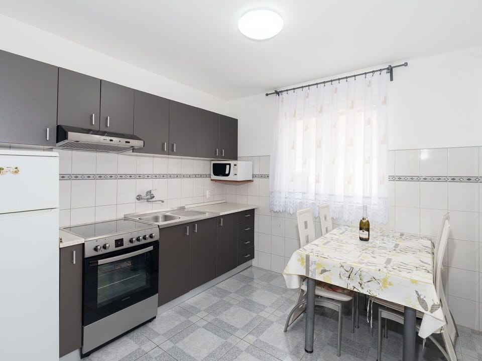 Flooring, Floor, Interior Design, Furniture, Kitchen, Ceiling, Room, Lighting, Cabinetry, Major Appliance
