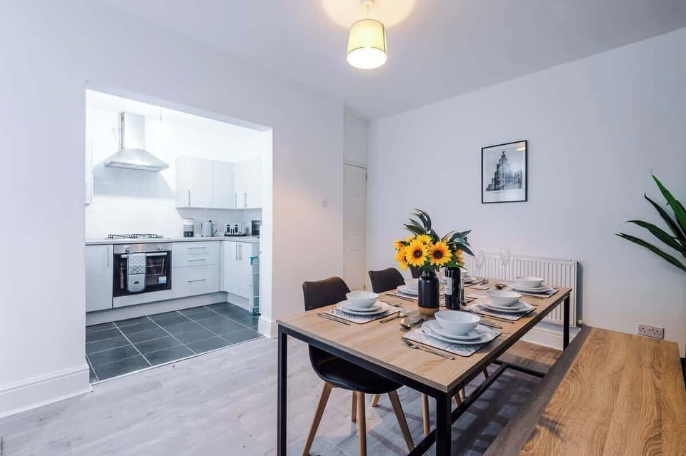 The dining room has a large dining table that can comfortably seat 6 people, perfect for an evening meal.