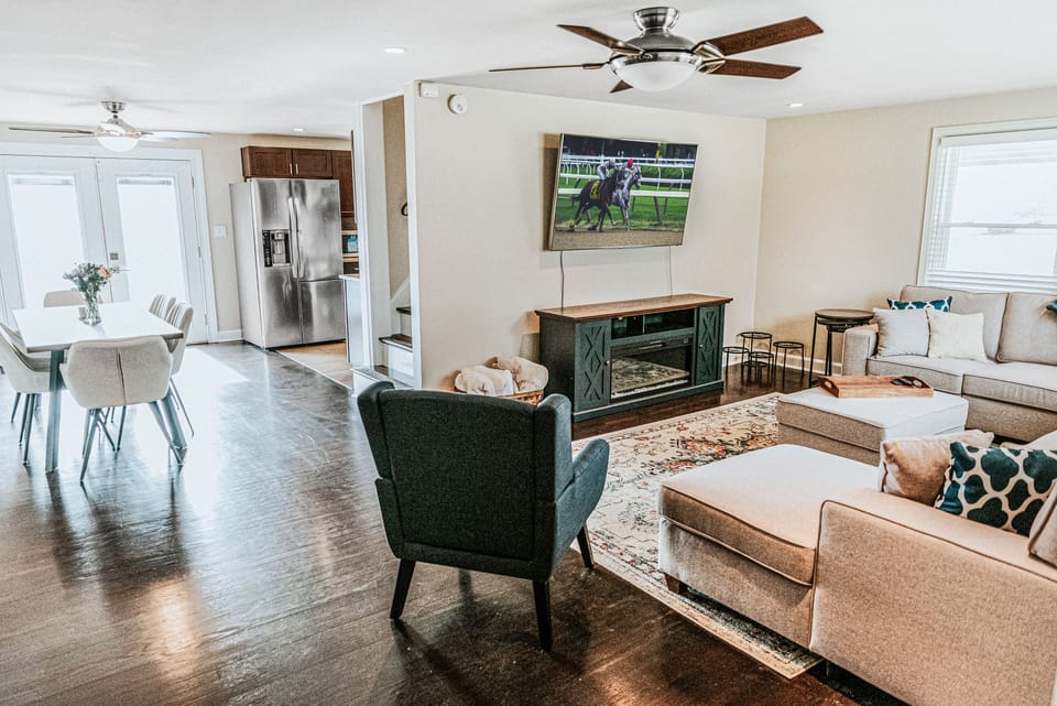 Bright and welcoming living area with smart TV and comfy seating.