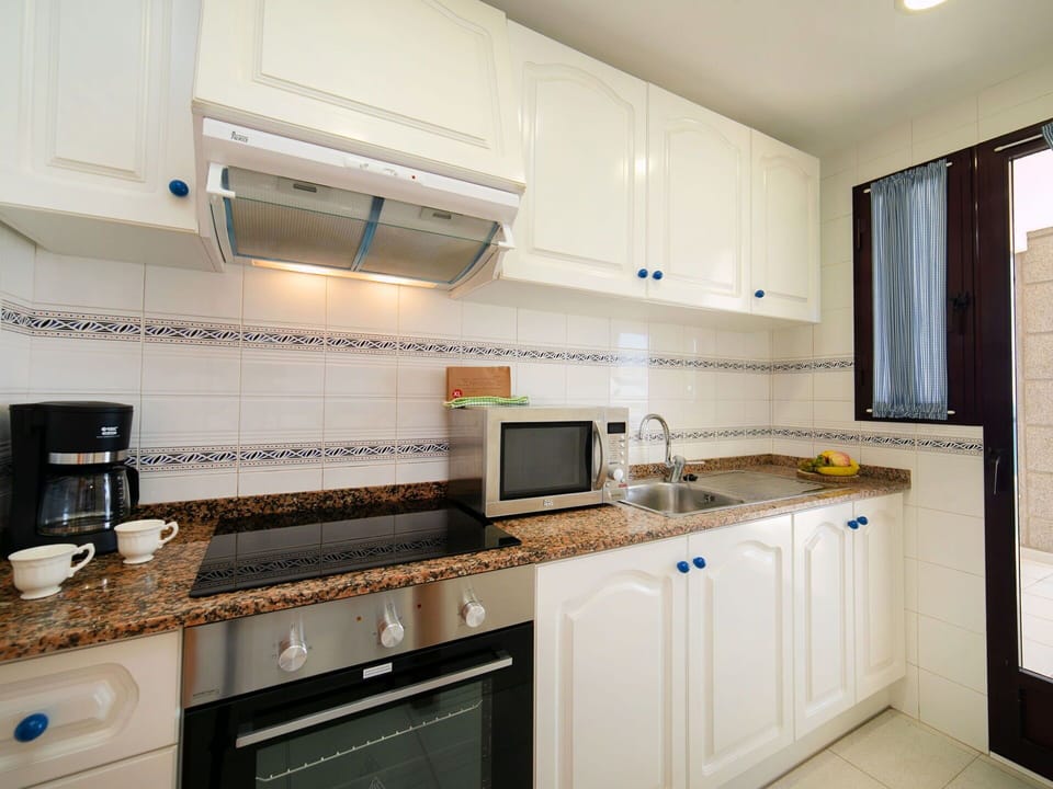 Countertop, Cabinetry, Kitchen Appliance, Building, Kitchen Stove, Home Appliance, Kitchen, Wood, Floor, Flooring