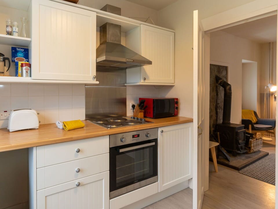 Cabinetry, Furniture, Countertop, Kitchen, Kitchen Appliance, Wood, Kitchen Stove, Building, Lighting, Interior Design