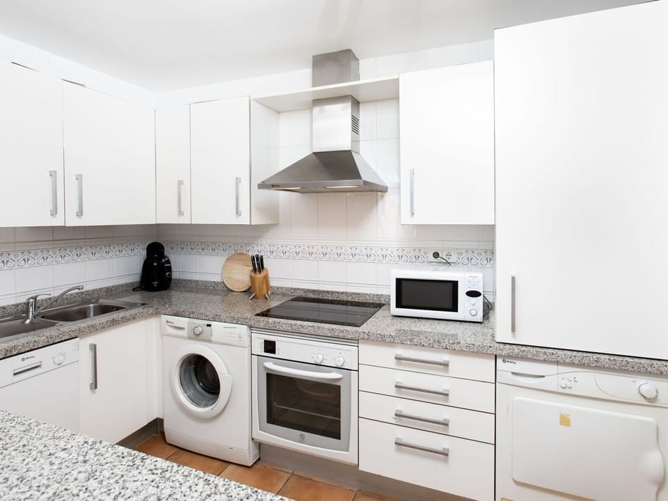 Cabinetry, Countertop, Property, Kitchen Stove, Home Appliance, Kitchen, Interior Design, Kitchen Appliance, Lighting, Flooring