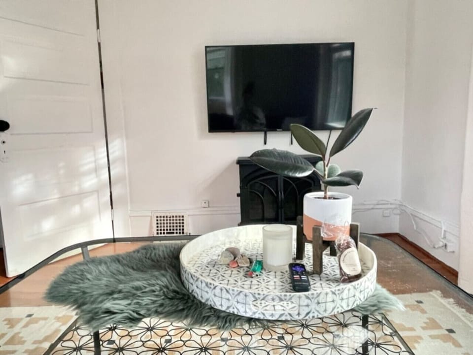 Living room with pull-out sofa, and desk! Also features a 55` Smart TV with Wifi and an electric fireplace :)