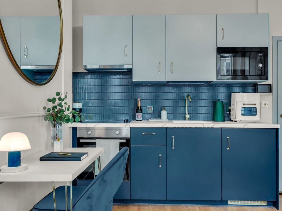 Blue, Furniture, Kitchen Appliance, Interior Design, Kitchen, Major Appliance, Flooring, Countertop, Cabinetry, Lighting