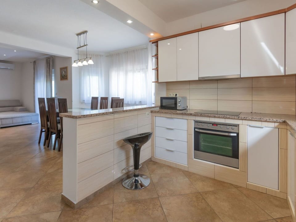 Cabinetry, Countertop, Furniture, Wood, Kitchen Appliance, Kitchen Stove, Building, Kitchen, Lighting, Flooring