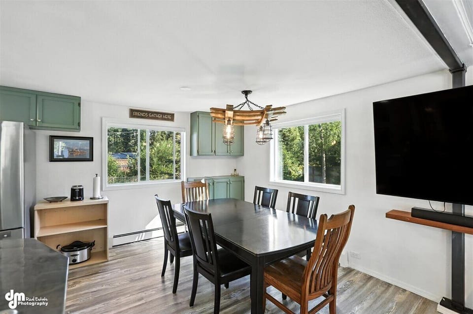 Family dining off kitchen surrounded by windows and full of natural light.