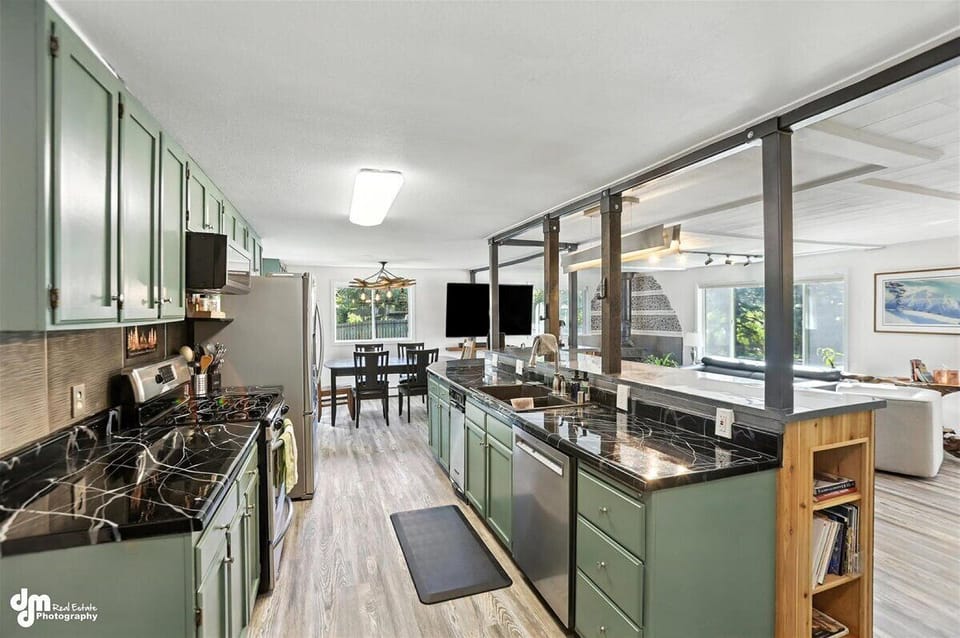 Fully-stocked kitchen features a custom cement island/counter and coffee bar.