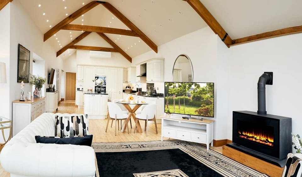 Cosy up in our inviting living room adorned with a charming fireplace, where warmth and comfort await.