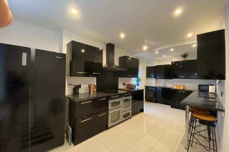 Kitchen, showing American style fridge-freezer, range cooker, washer-dryer, sink